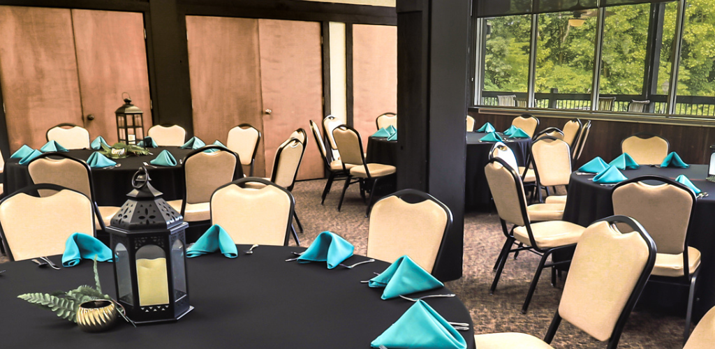 Round Tables set for a banquet meal with view of outdoors